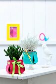 Plant pots with colourful felt covers as ornaments or as gifts