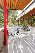 White table and ornate iron chairs on balcony