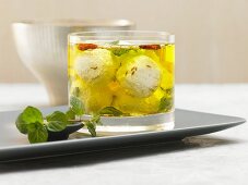 Homemade sheep's cheese in a herb oil