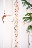 Garland of dried apple slices on shabby-chic door