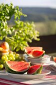 Watermelon on table set for summer picnic