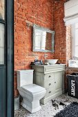 Vintage-style furnishings and brick walls in bathroom