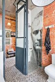 Shower with mosaic of Napoleon on wall in loft apartment with brick walls