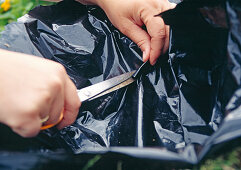 Plant the Hanging basket: Cut holes in the foil