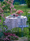 Table with arrangement of pink (rose), Paeonia (peony)