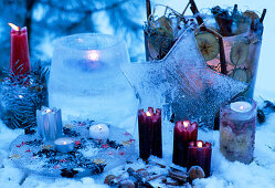 Candle containers made of ice with frozen flowers, fruits etc.