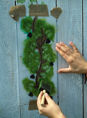 Painting a wooden wall with ivy vines using a stencil