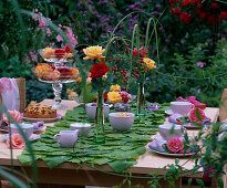 Aristolochia (Pipevine leaves) as table runners, pinks (roses) and rose hips