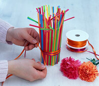 Carnations in a glass with coloured straws (2/3)
