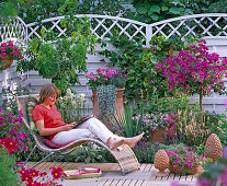 Patio with a Mediterranean ambience, woman on basket lounger