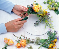 Wreath with orange roses and borage