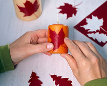 Decorating candles with wax leaves (2/3)