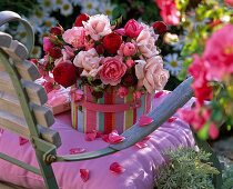 Pink (rose) bouquet in bag on the chair