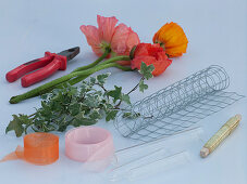 Table arrangement of silk poppies in wire mesh (1/5)