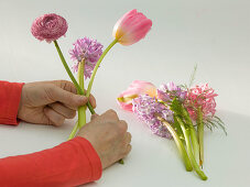 Tying a bouquet with tulips, hyacinths and ranunculus (2/5)