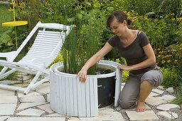 Installing wood paneling for mini-pond