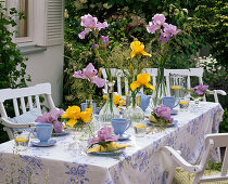 Table decoration with irises and grasses, blue place settings