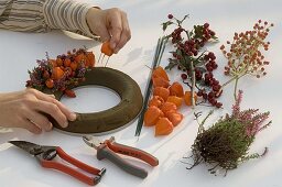 Wreath stuck with lanterns and rosehips