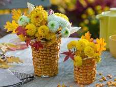 Glass vases covered with corn kernels