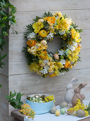 White-yellow scented wreath hung on wooden wall