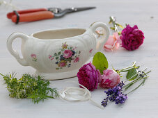 Porcelain sauce boat diverted with roses and herbs