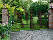 View into the garden through the wrought-iron gate