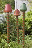 Colorful painted clay pots on pylons as beneficial shelter