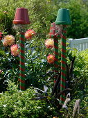 Colorfully painted clay pots on piles as beneficial shelter