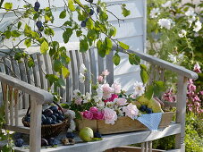 Freshly harvested plums, pears and freshly cut flowers