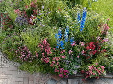 Bed with perennials, summer flowers and grasses