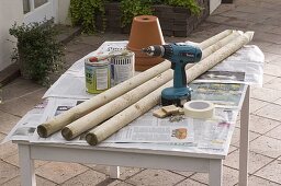 Painted pots on painted sticks in a flowerbed (1/10)