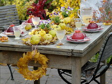 Table decoration with quinces on a carpet of leaves