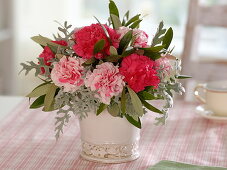 Small bouquet of Dianthus (carnations), Cineraria maritima (silver leaf)