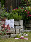 Dry stone wall made of granite blocks with seating niche