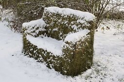 Grass sofa made of mild steel mesh and chicken wire snowed in winter