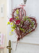 Heart made from branches of cornus (dogwood), red rose (roses)
