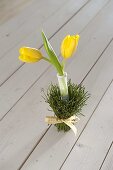Table decoration with yellow tulips and blueberry branches (3/4)