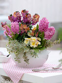 White tureen with Erysimum 'Winter Orchid' (golden violet), Hyacinthus 'Pink Pearl'.