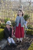 Children with palm bunches in the cottage garden