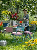 Table with gladiolus-dahlia bouquet under the apple tree