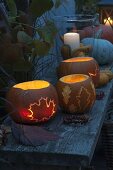 Luminous pumpkins with leaf decoration carved