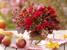 Red autumn bouquet: pink (rose, rose hips), leaves of Quercus (oak)