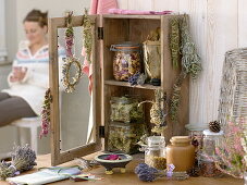 Small cupboard with dried herbs and smoked bundles
