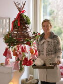 Homemade willow hat as Advent calendar, with numbered bags