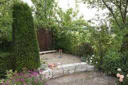 Children's play corner with sand, dry stone wall