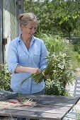 Tying a meadow bouquet with grain (2/5)