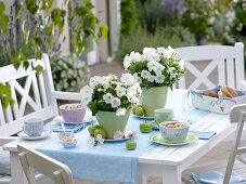 Green-white table decoration with petunias