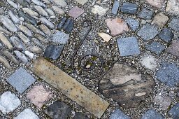 Interesting paved small terrace between beds