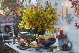 Bouquet made of fagus (beech) branches, bowls of quince