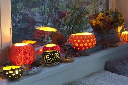 Window sill decorated with decorative carved pumpkins